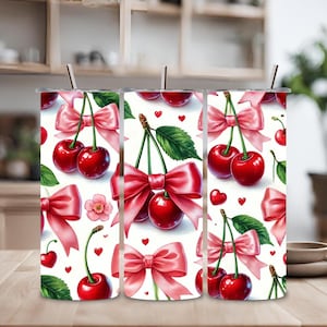 Puede incluir: Tres vasos de acero inoxidable con fondo blanco y un patrón repetido de lazos rosas y cerezas rojas.