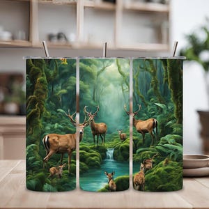 Puede incluir: Un juego de tres vasos de acero inoxidable con una escena de naturaleza con ciervos en un exuberante bosque verde. Los vasos están envueltos con un diseño de un bosque con un arroyo que lo atraviesa. Los ciervos son marrones y tienen cuernos.