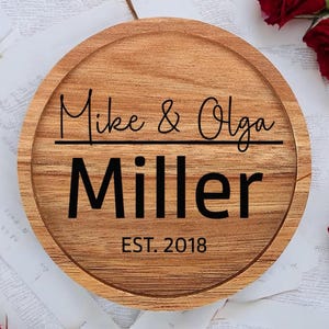 May include: A round wooden serving tray with the text "Mike & Olga Miller EST. 2018" engraved on it.