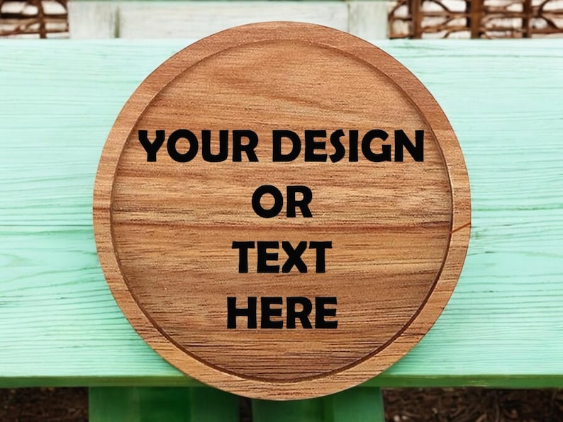 May include: A round wooden sign with the text "YOUR DESIGN OR TEXT HERE" in black lettering.
