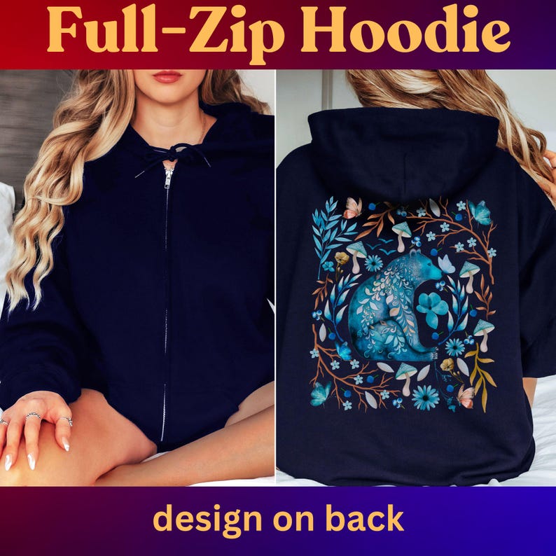 May include: Navy blue full-zip hoodie. The front features a full zipper closure. The back of the hoodie has a design with a blue bear surrounded by blue flowers, mushrooms, and butterflies. The text "Full-Zip Hoodie" and "design on back" are displayed.
