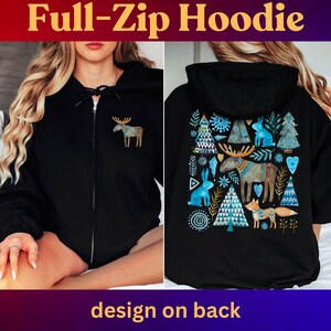 May include: Black full-zip hoodie with a colorful moose graphic on the front and a larger nature-themed design on the back. The back design includes trees, rabbits, and a fox. Text at the top reads "Full-Zip Hoodie" and "design on back" at the bottom.