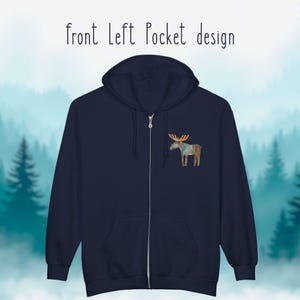 May include: Navy blue zip-up hoodie with a front left pocket design. The design features a watercolor-style moose with antlers and a patterned blanket. The text "front Left Pocket design" is above the hoodie.