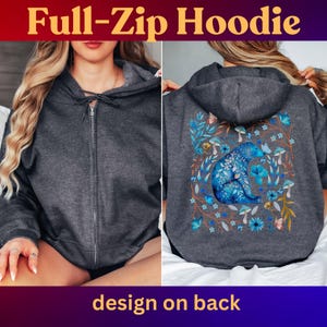 May include: Charcoal gray full-zip hoodie with a blue floral bear design on the back. The hoodie features a front zipper and a hood. The text "Full-Zip Hoodie" is at the top, and "design on back" is at the bottom.
