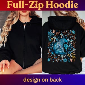May include: Black full-zip hoodie with a design on the back. The design features a blue bear surrounded by blue flowers, mushrooms, and butterflies. The text "Full-Zip Hoodie" is at the top of the image.