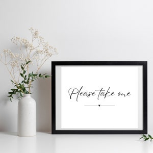 May include: Black framed print with white background and the text "Please take one" in black cursive font with a small heart symbol below the text.