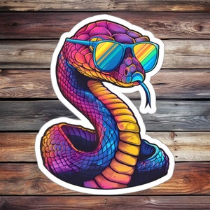 May include: A colourful snake wearing a pair of blue and yellow sunglasses. The snake is coiled and has a purple, blue and yellow colour scheme.