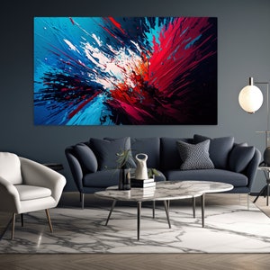 May include: Abstract painting with splashes of blue, red, white, and black paint. The painting is hanging on a dark blue wall in a living room setting.