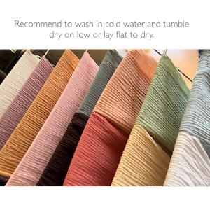 May include: A variety of colors of crinkled fabric hanging on a clothesline.  The fabric is a light weight and has a soft, textured feel.  Recommend to wash in cold water and tumble dry on low or lay flat to dry.