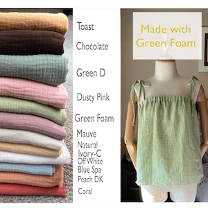 May include: A stack of 12 different colored fabric swatches, including toast, chocolate, green, dusty pink, green foam, mauve, natural, ivory, off white, blue spa, peach, and coral. The fabric is a soft, textured gauze. The text "Made with Green Foam" is written in yellow on a green background.