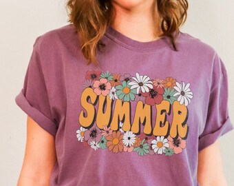 May include: A purple t-shirt with a floral design and the word "SUMMER" in a retro font.