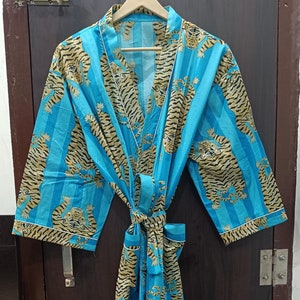 May include: A blue and brown striped robe with a tiger print. The robe has a tie belt and long sleeves.