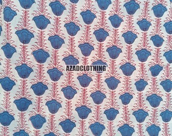 May include: White fabric with a repeating pattern of blue flowers with red stems. The fabric has the text "AZADCLOTHING" printed on it.
