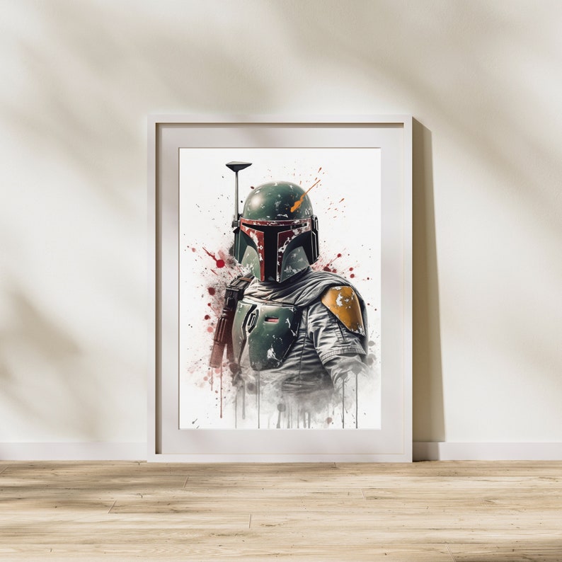 May include: A white framed print of a watercolor painting of Boba Fett, a fictional bounty hunter from the Star Wars universe. The painting features a green and brown helmet with a red visor, a yellow shoulder pad, and a blaster rifle. The background is white with red and orange splatters of paint.