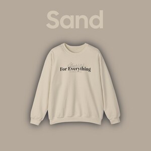 May include: A sand-coloured sweatshirt with the text "Alhamdulillah For Everything" in black lettering.