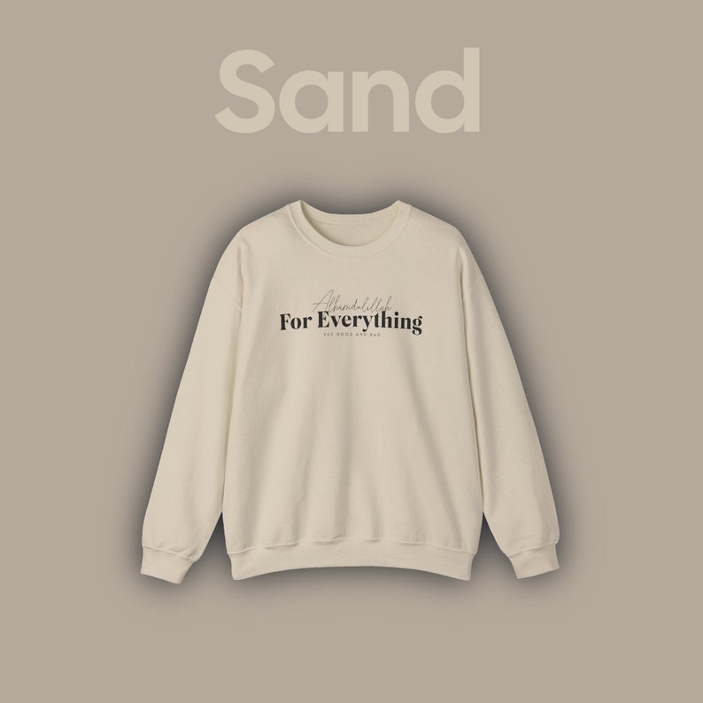 May include: A sand-coloured sweatshirt with the text "Alhamdulillah For Everything" in black lettering.