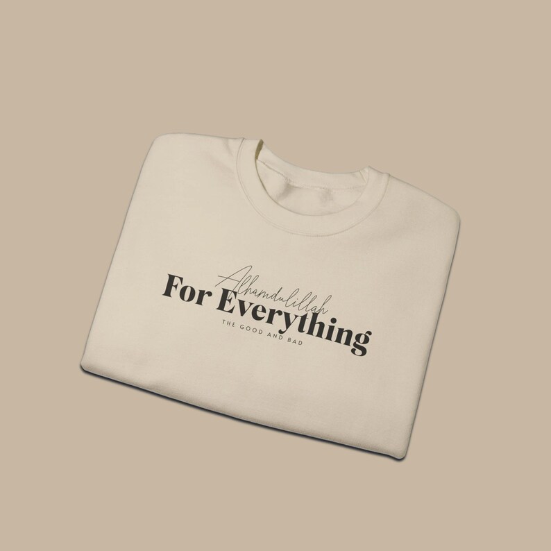 May include: A white sweatshirt with the text "Alhamdulillah For Everything The Good And Bad" printed on the front.