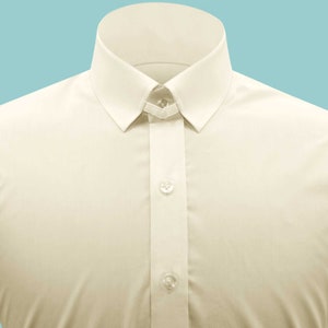 May include: A cream-colored dress shirt with a button-down collar and two buttons visible on the front.