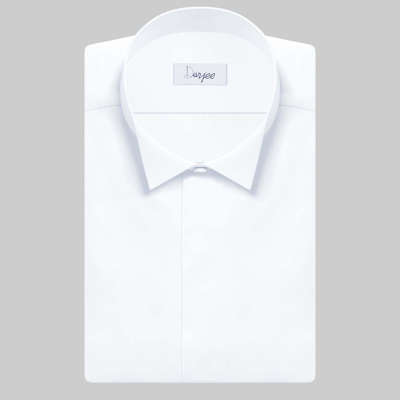 May include: A white dress shirt with a wing collar and a single button closure. The shirt has a label that says "Darjee".