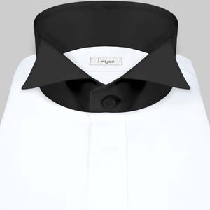 May include: A white dress shirt with a black collar and a single black button. The shirt has a label that says "Darjee".
