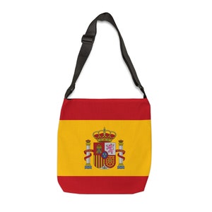 Op de afbeelding: Een schoudertas met de vlag van Spanje. De tas heeft een rood-geel ontwerp met het Spaanse wapen in het midden. Hij heeft een zwarte, verstelbare riem.