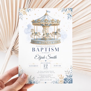 May include: A baptism invitation card featuring a watercolor carousel with blue and gold accents, surrounded by floral illustrations. The text reads: PLEASE JOIN US TO CELEBRATE THE BAPTISM OF OUR SON Elijah Smith DECEMBER 12 2026 SATURDAY 10:00 AM.