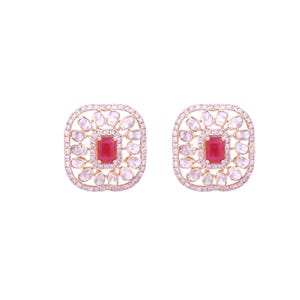 May include: A pair of square-shaped stud earrings. Each earring features a central rectangular red gemstone surrounded by clear, irregularly shaped stones. The outer edge is lined with small, clear stones, all set in a gold-colored metal.