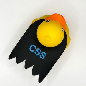 May include: A yellow rubber duck with a black cape and the word "CSS" written in blue letters.