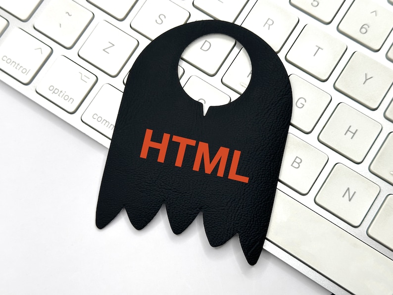 May include: A black leather door hanger with a cut-out for a door knob. The hanger has a jagged bottom edge and the word "HTML" written in orange letters.