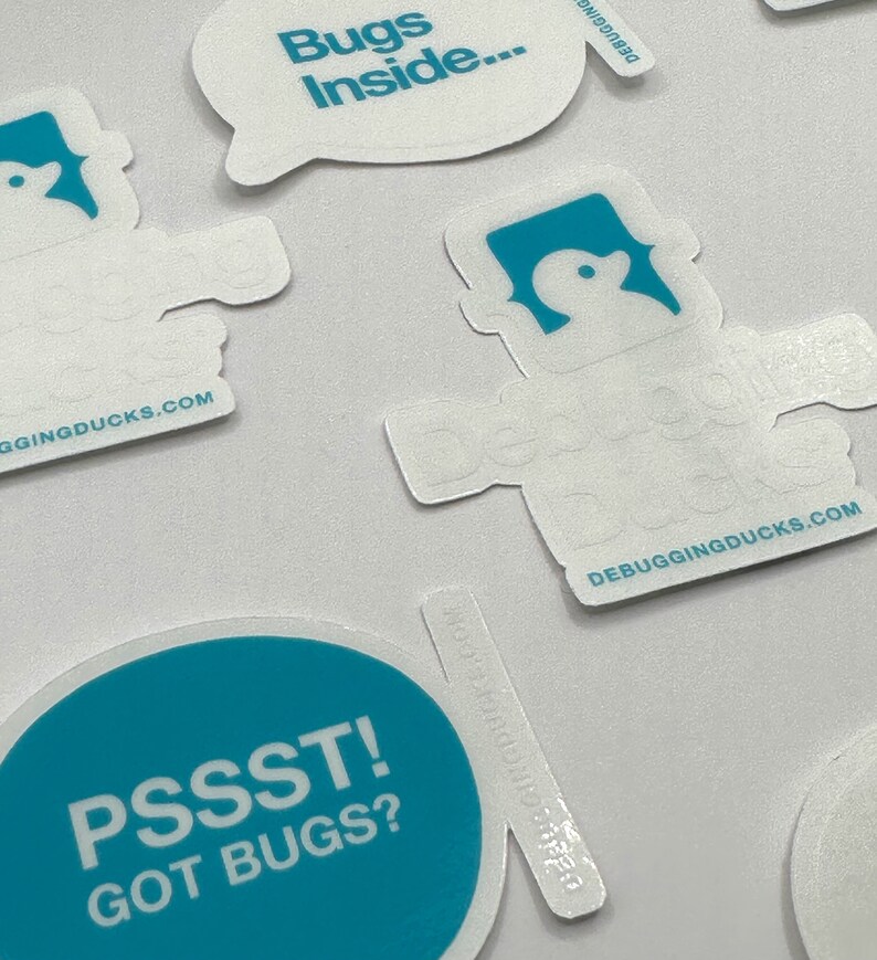 May include: A set of four teal blue and white stickers with the text "Bugs Inside...", "Pssst! Got Bugs?", and "Debugging Ducks.com". One sticker features a cartoon duck with a speech bubble.