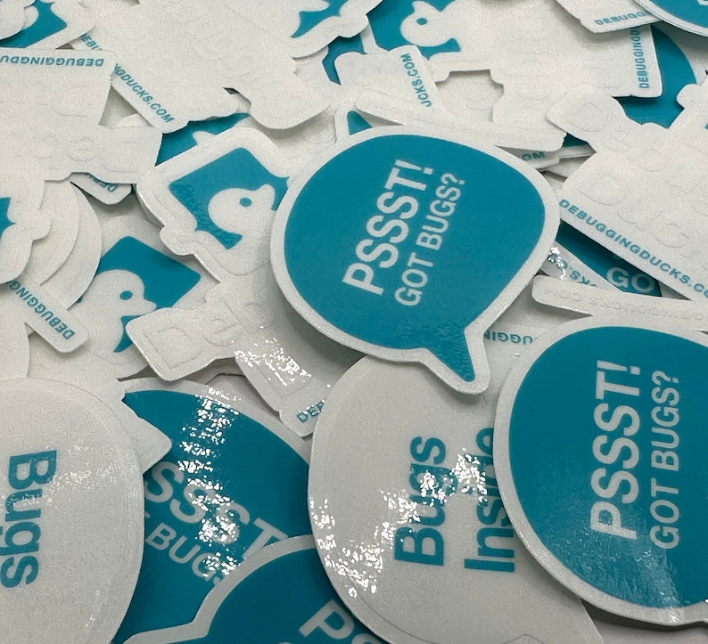 May include: A close-up of several teal blue and white round stickers with the text "PSSST! GOT BUGS?" printed on them. The stickers are arranged in a pile and have a glossy finish.