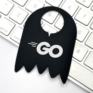May include: Black door hanger with a white "GO" logo and three white lines above the logo. The door hanger has a cut-out at the top for hanging.