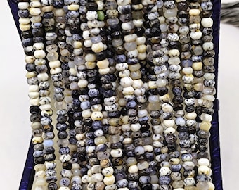 May include: A strand of small, faceted, multi-colored opal beads. The beads are a mix of white, black, gray, and brown. The beads are in a box.