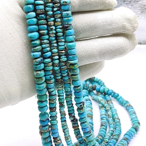 May include: A strand of turquoise beads, with a mix of blue and green tones, in various sizes. The beads are strung on a cord and are ready to be used for jewelry making.