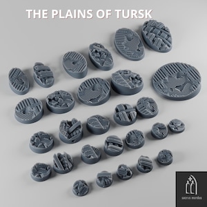 May include: A collection of gray, textured miniature bases in various shapes and sizes. The bases feature detailed designs, including geometric patterns and simulated terrain. The text "THE PLAINS OF TURSK" is at the top of the image.
