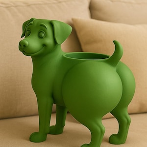 Puede incluir: Una maceta verde con forma de perro con una cara sonriente y una abertura redonda para plantas. El perro tiene un diseño juguetón con la cola levantada y su trasero en un lugar destacado. La maceta está hecha de un material sólido.