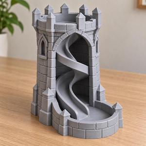 May include: A gray 3D-printed dice tower shaped like a castle turret with a stone brick texture. The structure features a hollow interior with a spiraling ramp that leads from the top opening down to a curved tray at the base for rolling dice.