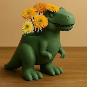 May include: A green dinosaur-shaped vase holding yellow and orange gerbera daisies. The vase is a matte green color and has a detailed, textured surface. The flowers are vibrant and add a pop of color.