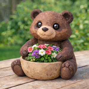 May include: A brown bear-shaped planter holding a bowl of colorful flowers. The bear has a carved wood texture, large black eyes, and a smiling expression. The flowers include pink, white, and purple blooms. The planter sits on a wooden surface.
