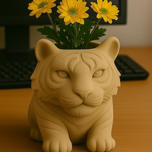May include: A tan-colored tiger-shaped planter holding yellow flowers with green centers. The planter is detailed with facial features and sits on a wooden surface. The flowers add a pop of color to the scene.