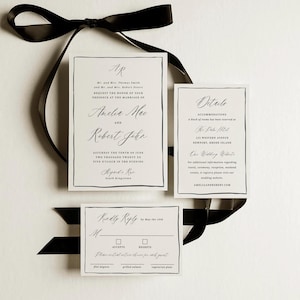 May include: Elegant wedding invitation suite with a black ribbon. The invitation includes the names Amelia Mae and Robert John, along with event details. A details card and RSVP card are also included.
