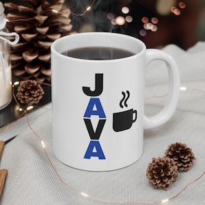 May include: White ceramic coffee mug with the word "JAVA" in black and blue lettering. A black coffee cup icon is next to the word. The mug is filled with dark liquid.