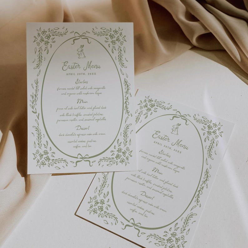 Pu&ograve; includere: Due carte bianche con bordi floreali verdi e un'illustrazione di un coniglio. Le carte sono per un menu di Pasqua e elencano gli antipasti, il piatto principale e il dessert. Il testo sulle carte recita "Easter Menu" e "April 30th, 2023".
