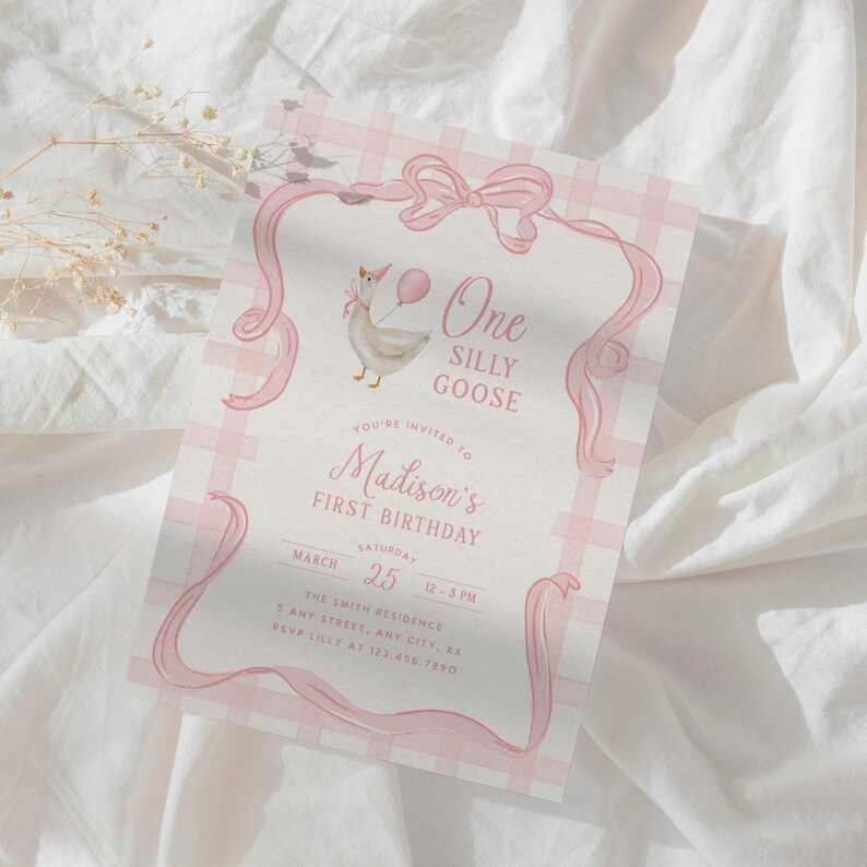 May include: A pink and white gingham patterned invitation with a watercolor illustration of a goose holding a balloon. The text reads "One Silly Goose" and "Madison's First Birthday". The invitation is framed with pink ribbons and a bow.