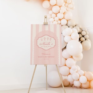 May include: Pink and white striped welcome sign with the text "Madie's Ice Cream Social" and "Welcome to Madie's 2nd Birthday 06.12.23".