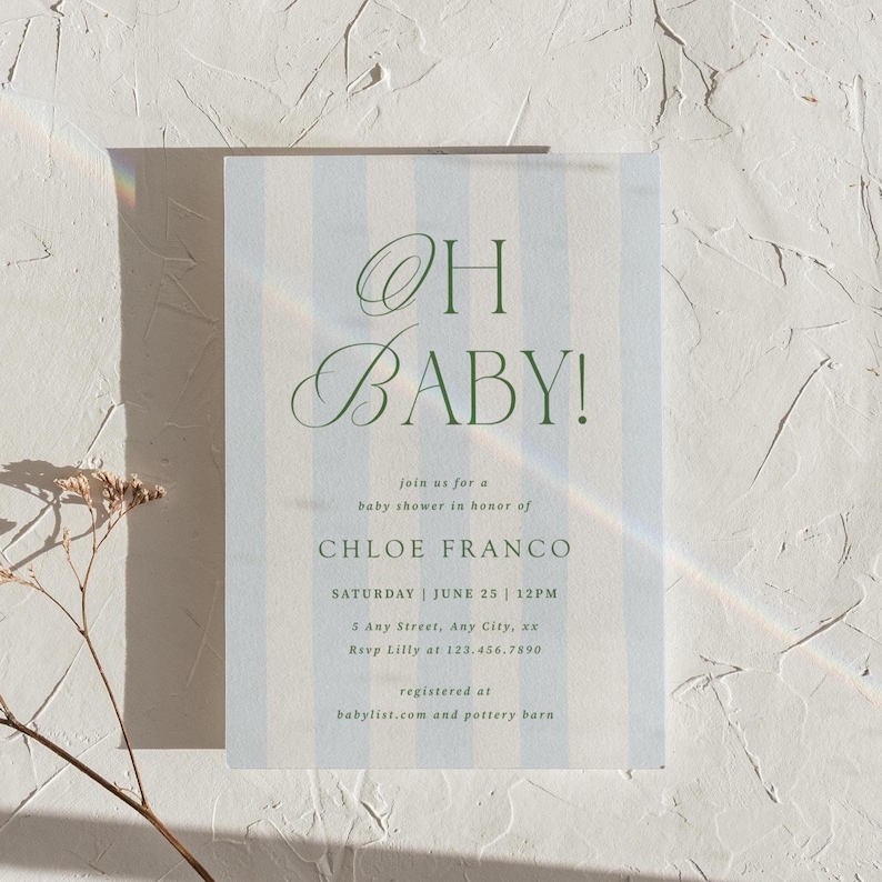 May include: Baby shower invitation with a light blue and white striped background. The text "OH BABY!" is in elegant green script. Additional text includes the name Chloe Franco, date, time, and RSVP information.