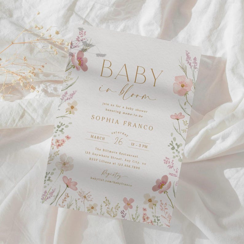 May include: A baby shower invitation with a floral design. The invitation reads "Baby in Bloom" and includes the name "Sophia Franco" and the date "March 26".