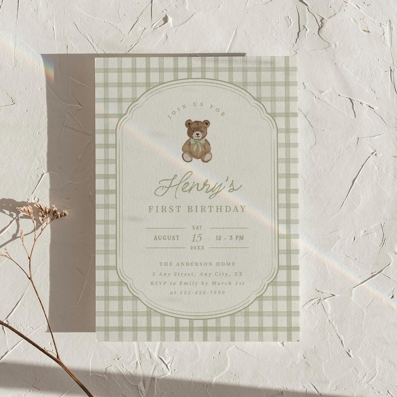 May include: A first birthday invitation with a teddy bear illustration. The invitation features the text "Henry's First Birthday" and event details, including the date, time, and location, set against a green gingham pattern.