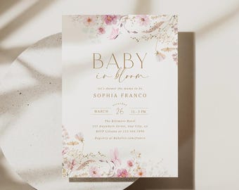 May include: A rectangular baby shower invitation card featuring gold text that reads BABY in bloom, let's shower the mama-to-be, SOPHIA FRANCO, MARCH 26, 12-5 PM, The Biltmore Hotel, 123 Anywhere Street, Any City, xx, RSVP Liliana at 123.456.7890, Registry at Babylist.com/franco, decorated with watercolour pink flowers and butterflies.