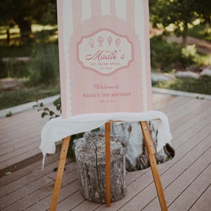 May include: Pink and white striped sign with the text "Maddie's Ice Cream Social Est. 20XX" and "Welcome to Maddie's 2nd Birthday 08.15.XX".